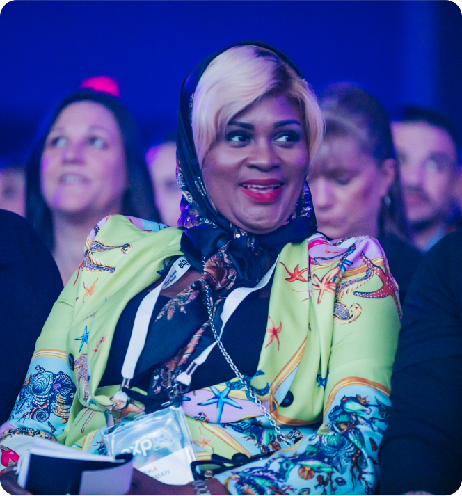 A woman wearing a colorful outfit, representing "Diversity, Equity & Inclusion" at an event.